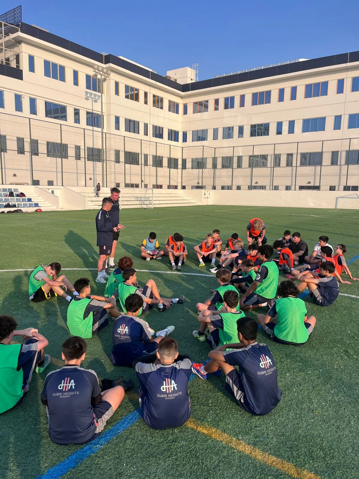 Coach briefing players on the pitch